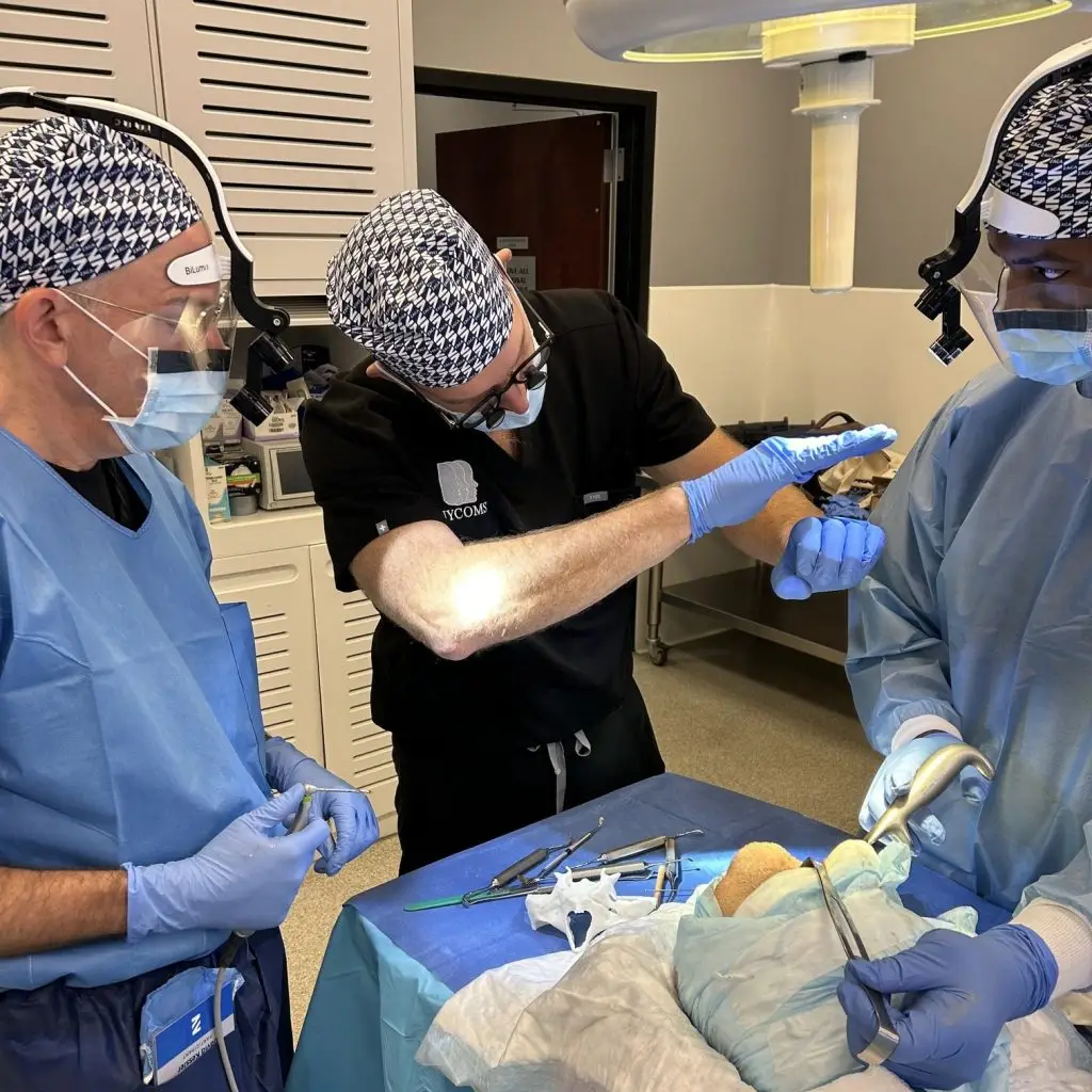 Participants receiving instructions from specialist doctors during surgeries on cryopreserved human heads